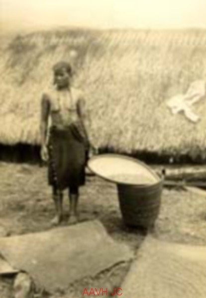 An old photograph of a highland woman standing with a basket