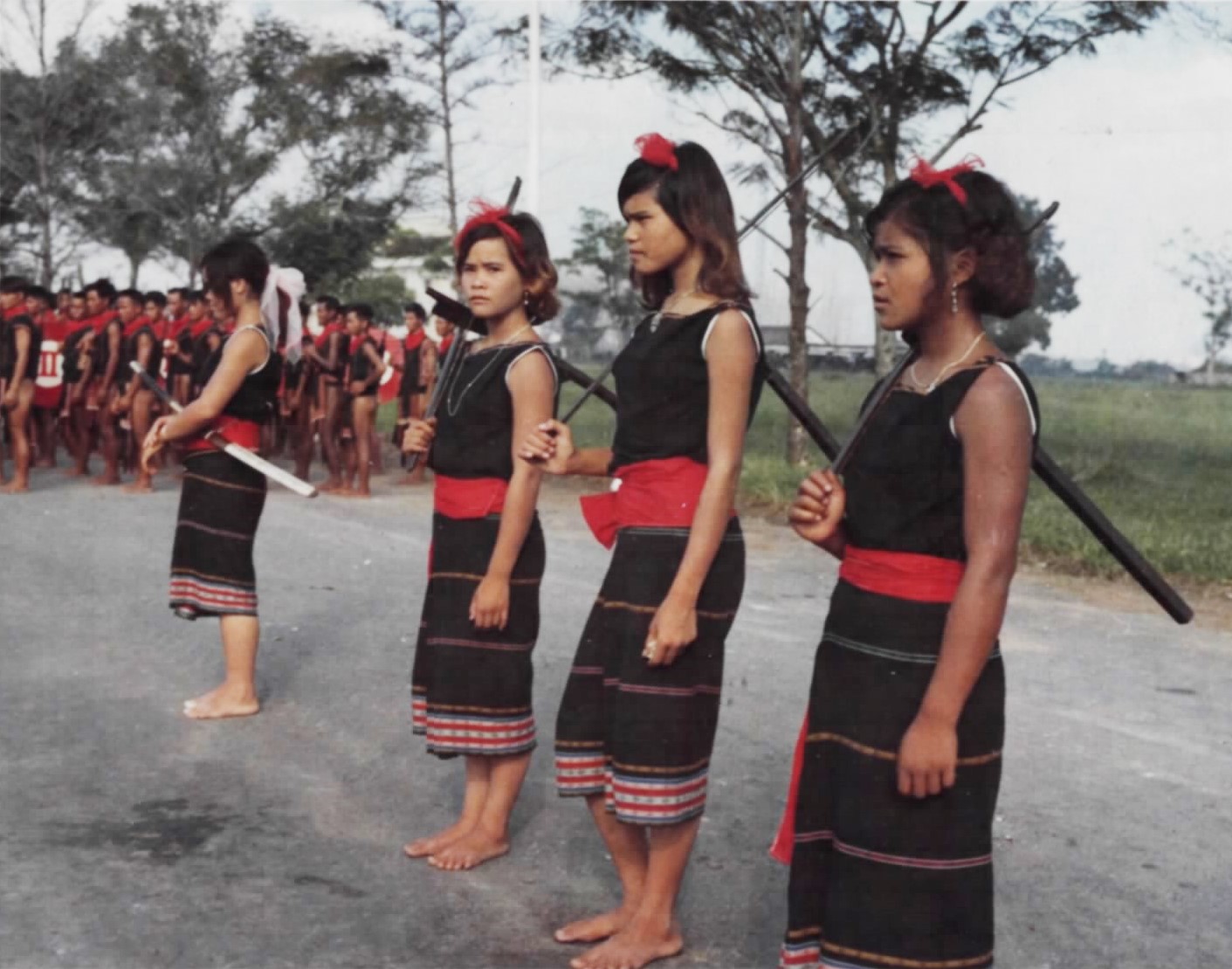Montagnard militiawomen marching in a parade with rifles