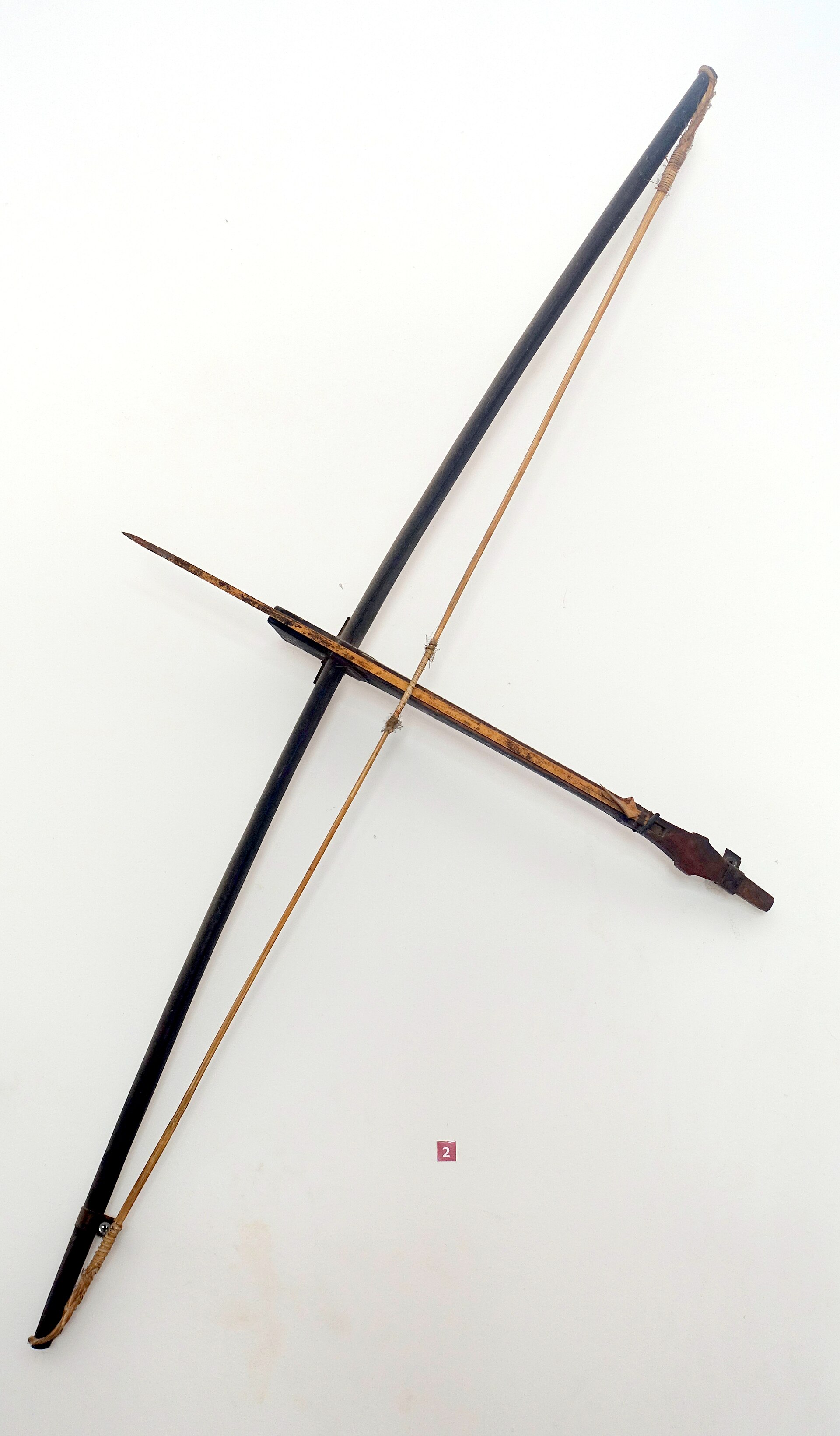 A wooden crossbow with a bamboo bow, seen from above