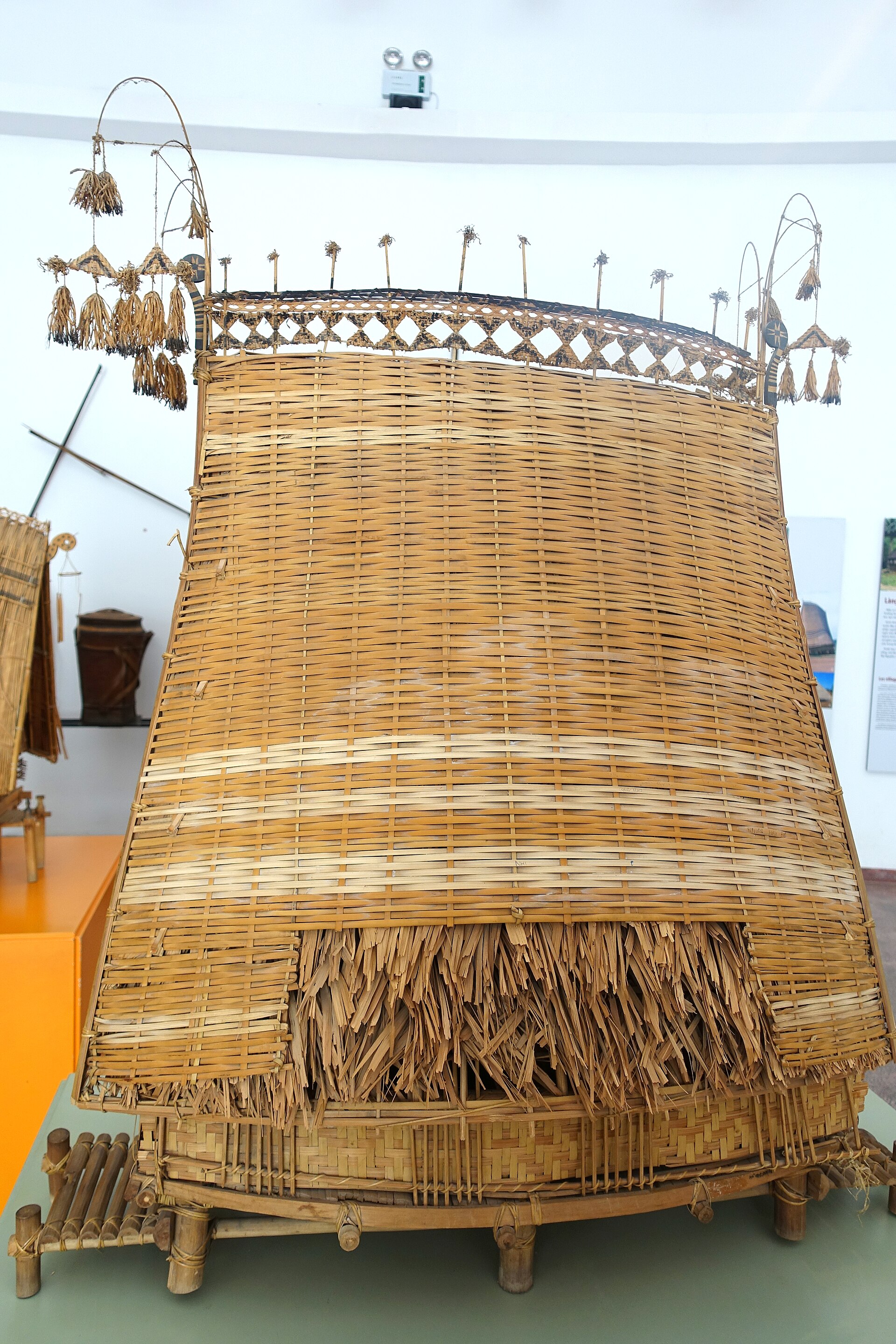 A model of a Sedang communal house with a tall roof